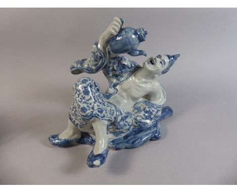 An Oriental Blue and White Ceramic Study of Reclining Gent Drinking Tea Directly from a Teapot.  Four Character Mark to Base.