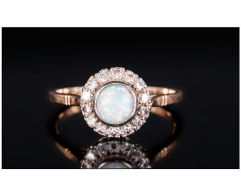 18ct Gold Circular Set Diamond & Opal Ladies Dress Ring, The central & round opal surrounded by 20 small diamonds. Marked 18c