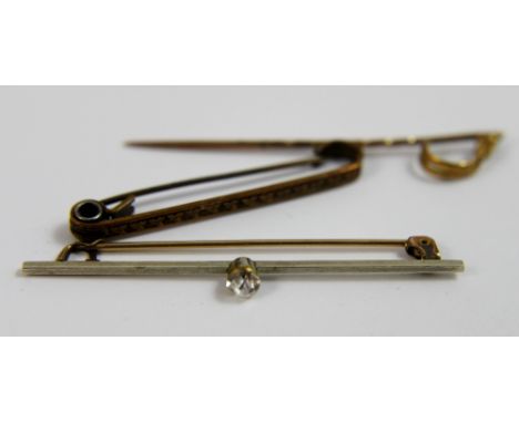 Two yellow metal bar brooches, one with stone set in bar and a yellow metal tie pin