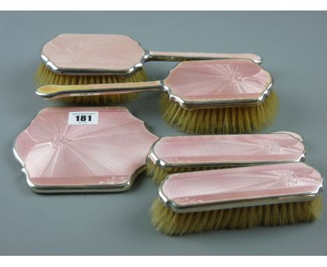 A five piece silver and pink enamel Art Deco dressing table set, Birmingham 1936 with engine turned decoration, comprising of