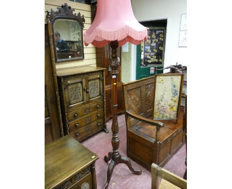 An early 20th Century carved wooden standard lamp and shade