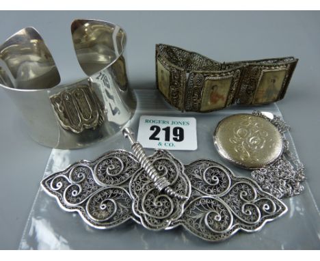 A lady's wristband stamped 925, a hallmarked silver circular locket with chased decoration and chain, an Oriental filigree br