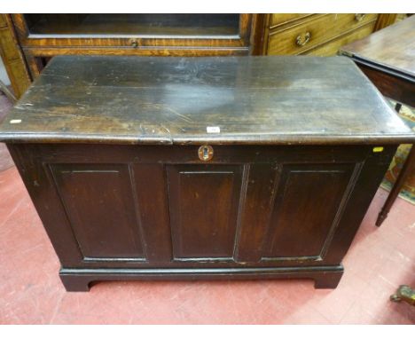 A late 18th Century oak dower chest having a triple fielded panel front on corner bracket feet, 106 cms long