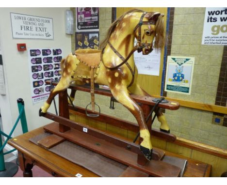 A 20th Century compact trestle rocking horse (mane and tail intact)