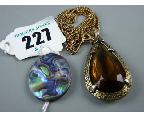 A nine carat gold fine link chain with a yellow metal framed pear shaped amber stone pendant and an oval abalone and silver p