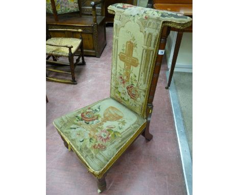 An Edwardian mahogany prie-dieu chair, the tapestry back with a cross amongst flowers, the seat with a chalice amongst flower