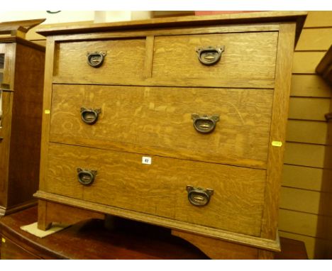 A late Victorian oak chest of two short over two long drawers with copperized ring pull handles on block and ogee bracket fee
