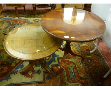 A reproduction yew circular topped tripod table with centre ebony and light wood inlay and a mahogany piecrust revolving top 