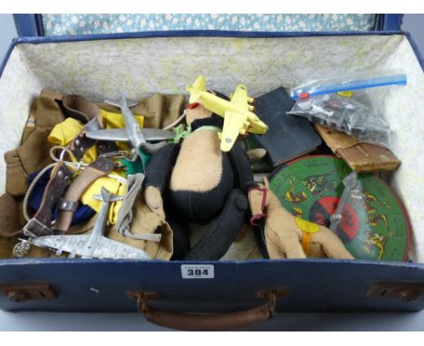 A vintage suitcase and contents to include a Boy Scout uniform, a felt monkey and horse, a tinplate race game wheel, a quanti