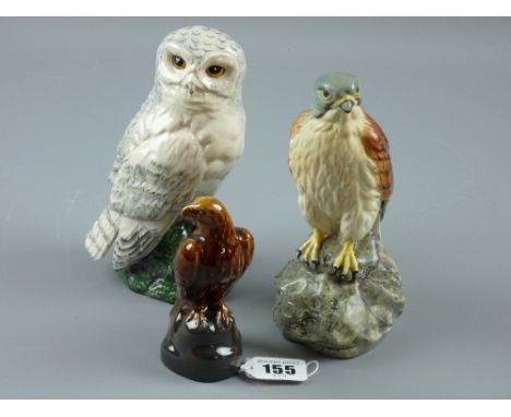 Three ceramic bird decanters, Royal Doulton snow owl for Whyte & Mackay, Beswick kestrel for Beneagles and a Peter Thompson, 