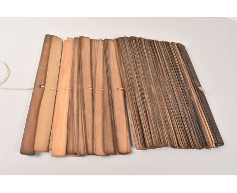 A Middle Eastern Palm Leaf Manuscript, possibly Indonesian, with etched lettering to each leaf, 31cm in length