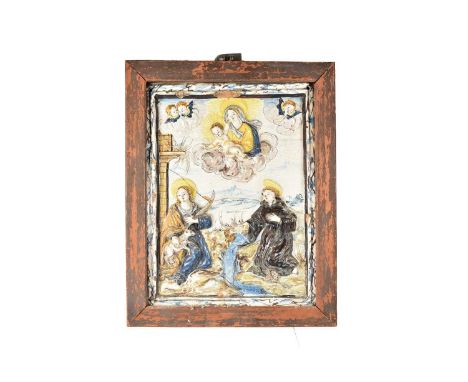 A 17th Century Italian Maiolica Wall Plaque, possibly Deruta, moulded in relief with the Virgin and Christ Child, in heaven a