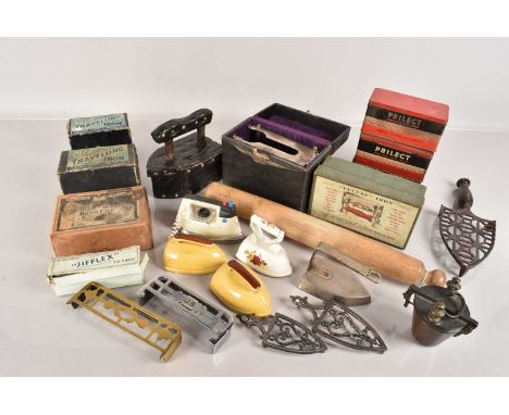 An assortment of various items, comprising a toy iron, ceramic irons, advertising tins, wooden iron, rolling pin trivets and 