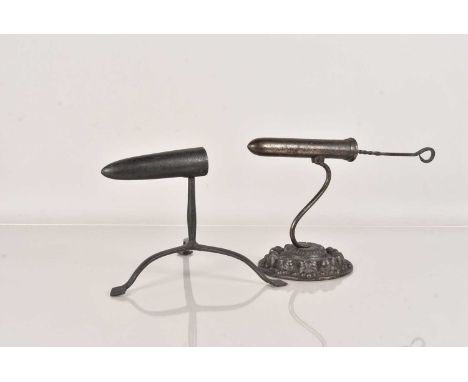 An Antique Goffering Iron, having a circular, ornately decorated cast metal base, complete with poker, together with another 