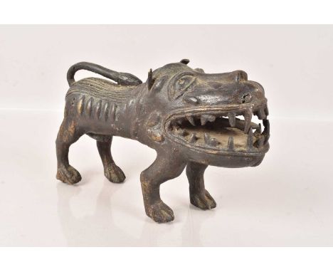 A Benin Bronze Animal Figure, possibly a Leopard or Dog, with enlarged head and mouth, 21cm long