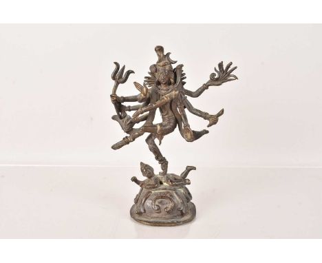 A late 18th Century/early 19th Century Indian Bronze of the Goddess Kali, modelled standing on a Prostrate Consort, 17cm Hlig