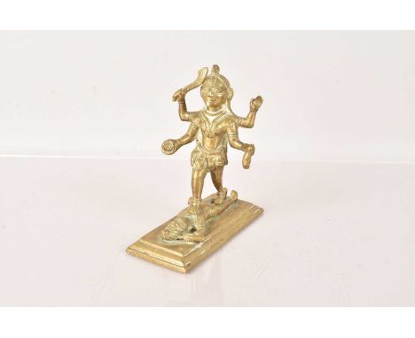 An early 20th Century Indian Hindu Bronze Figure of Kali, the Goddess depicted in her typical form, her four arms carrying va