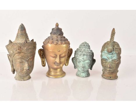 Four small Buddha Heads, three in bronze, one in brass, including examples from Thailand, Benin and two other Middle Eastern 