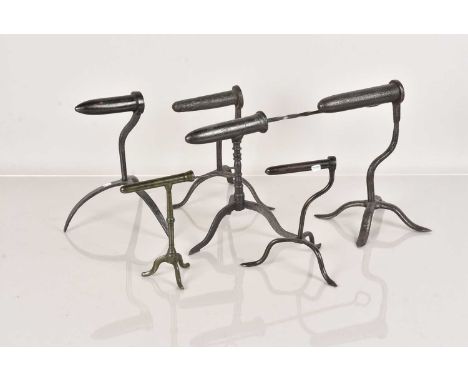 A group of six Goffering Irons, all of similar design and style, five on tripod legs, one on four legs, comprising four large