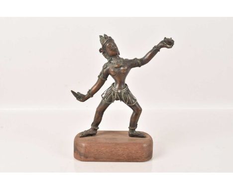 An Oriental Bronze figure of Dakini, dancing and wearing a skirt of chains, with later fitted wooden stand, 18cm H excluding 