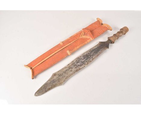 A Salampasu Sword, having shaped double edge blade, with wooden grip, complete with scabbard, blade 41cm long, no postage for