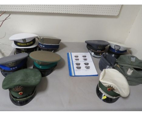 Two trays of assorted military hats to include Polish Army examples 