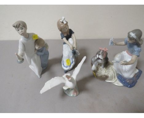 A Lladro figure of a girl nursing a dog together with another, a Nao figurine and another A/F (4)