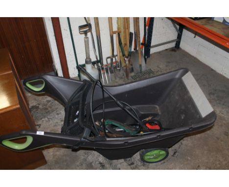 A selection of garden tools to include a wheelbarrow 