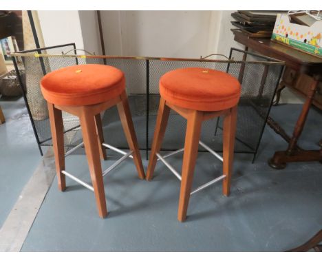 A pair of retro stools together with a firescreen 