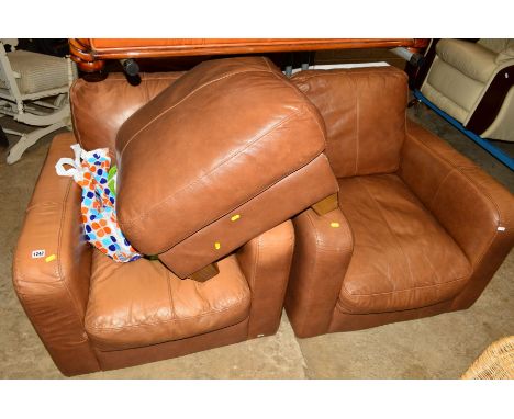 A PAIR OF BROWN LEATHER ARMCHAIRS and a similar pouffe (3)