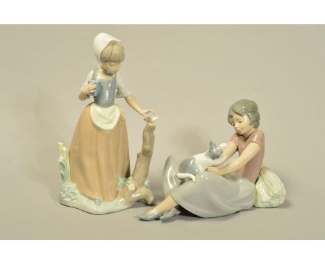 TWO NAO FIGURINES, to include girl playing with Cat, length 20cm and girl with Butterfly, height 22cm (2)