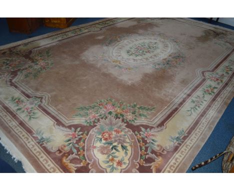 A WOOLLEN CHINESE RUSSET AND LIGHT BROWN CARPET SQUARE, 522cm x 340cm (some darker patches, staining and tassels worn)