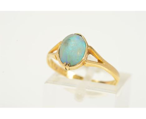 A LATE VICTORIAN 18CT GOLD OPAL RING, designed as an oval opal cabochon in a collet and claw setting, to the bifurcated shoul