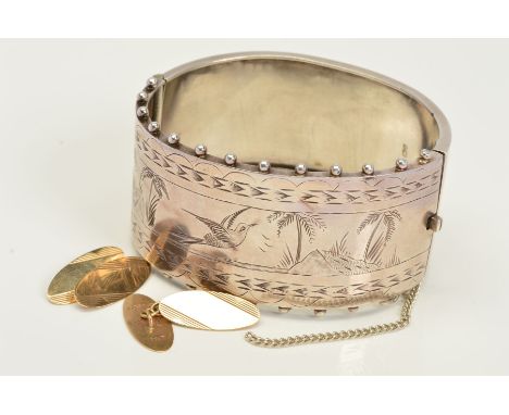 TWO ITEMS OF JEWELLERY, to include a late Victorian silver hinged cuff bangle, half engraved with Oriental birds and palm tre