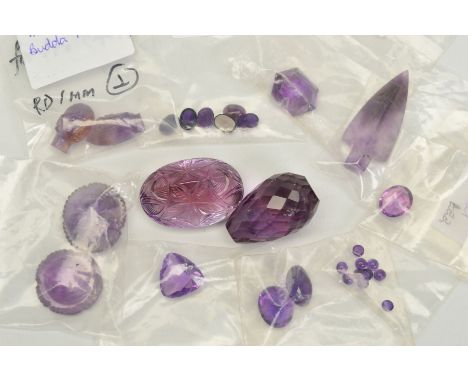 A QUANTITY OF AMETHYST STONES, to include a carved stone, an arrowhead, cabochon cuts, various faceted cuts and two large ame