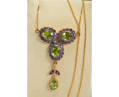 A PERIDOT AND AMETHYST PENDANT NECKLACE, designed as three oval peridots each within circular amethyst surrounds suspending a