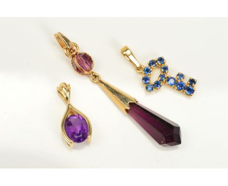 THREE PENDANTS, the first designed as an oval amethyst within a wishbone shape surround, stamped 14k, the second a key shape 