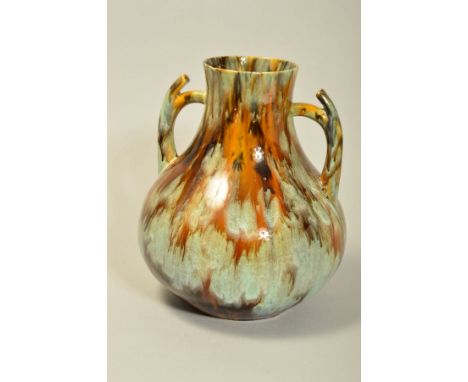 AN ART NOUVEAU STUDIO POTTERY TWIN HANDLED VASE, the body being covered in a streaked glaze, unmarked to the base, similar in