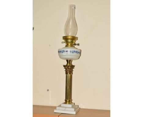 A BRASS OIL LAMP, with Corinthian column, glass reservoir, on stepped marble effect base, with glass funnel, no shade, approx