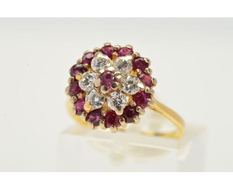 A RUBY AND DIAMOND CLUSTER RING, the central circular ruby within a brilliant cut diamond surround and outer circular ruby bo