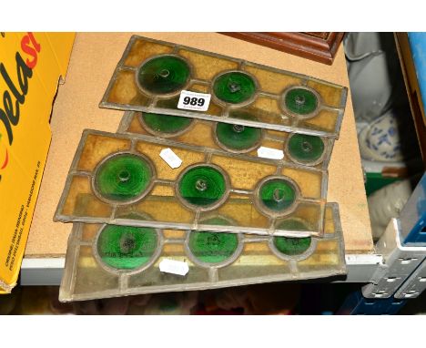 FOUR LEADED LIGHT WINDOW PIECES, each having three green 'Bulls Eyes' to the centre, each measuring approximately 24cm high, 