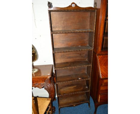 AN EARLY 20TH CENTURY OAK SIX TIER OPEN BOOKCASE, the top shelf flanked by a pair of owl figure finials, each tier joined by 