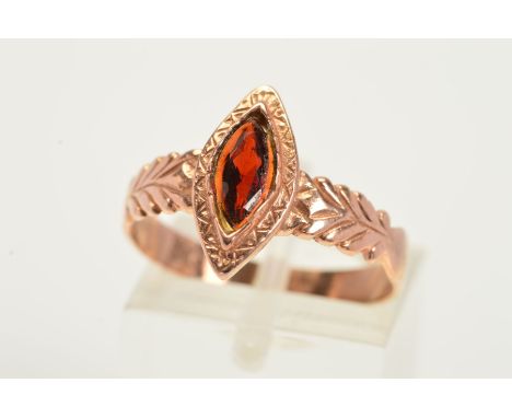 A GARNET RING, designed as a navette shaped garnet within an engraved navette shaped surround, to the leaf design shoulders, 