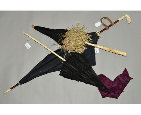 THREE LATE 19TH TO EARLY 20TH CENTURY BLACK PARASOLS, the first with carved bone handle, pink inner lining and straw trim, no