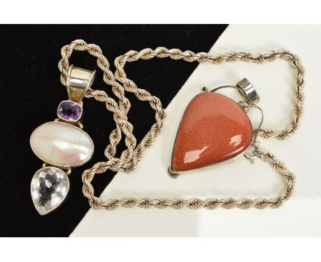 TWO GEM PENDANTS, the first a pear shape goldstone cabochon with scrolling detail to the top of the mount, the second set wit