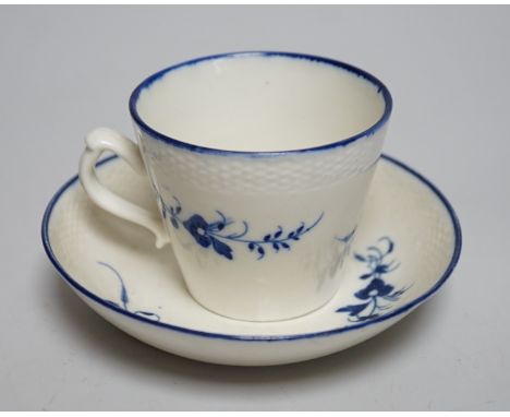 An 18th century Caughley coffee cup and saucer, Chantilly sprigs under a basket weave moulded border, saucer 13cms diameter