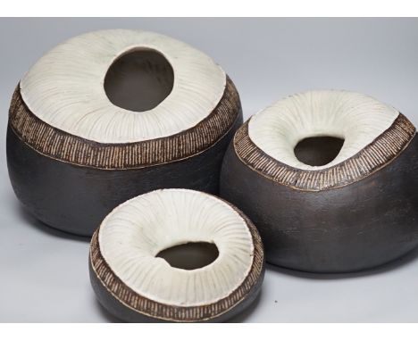 Ruth Sulke - a set of three graduated shell-like circular pottery vases, each inscribed R/S on base, tallest approximately 25
