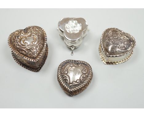 Three Victorian/Edwardian repousse silver heart shaped trinket boxes, largest 56mm and a similar mother of pearl inlaid 'pans