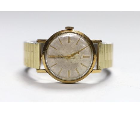 A gentleman's 1950's/1960's 9ct gold Tudor manual wind wrist watch, with baton numerals, and case back inscription, on associ