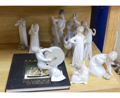 A Lladro collection: seven figures, five further damaged figures and a Lladro reference book